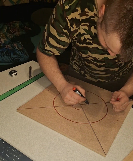 Artist marking geometric pattern on MDF board – handmade string art preparation process by Psybell