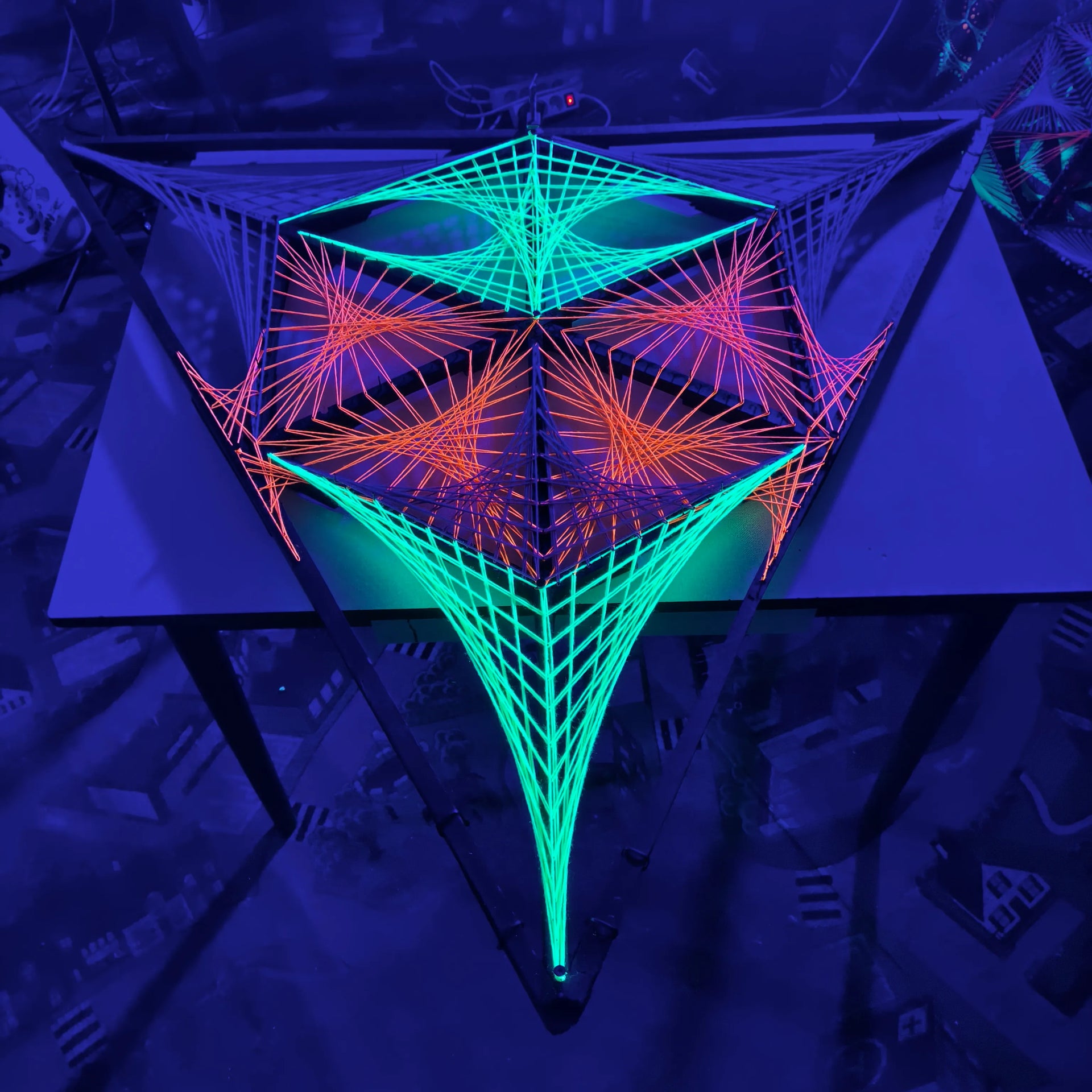 Load video: Alien Biohazard is a handmade UV reactive string art sculpture created by Psybell.In this video I explain the renovation process and the geometric structure of the artwork. During the restoration I improved several details, adjusted the nails and refined the circular elements to achieve a cleaner and more precise visual effect.Every line in this piece has a specific position and together they create the alien biohazard-like geometry visible from different angles.This artwork can be used as a psychedelic stage decoration or as a unique wall installation.🛒 www.psybell.art 🎁
