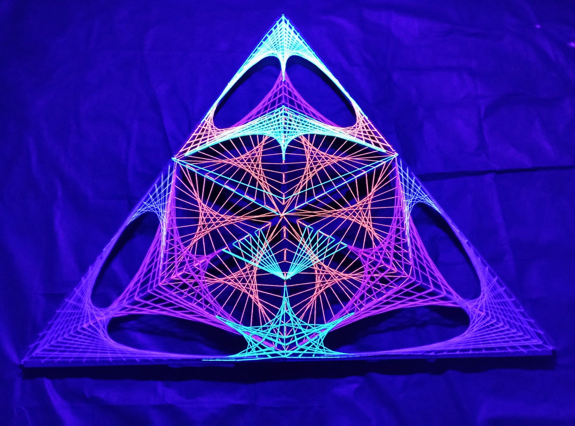 handmade UV reactive string art artwork with alien motif, geometric structure, glowing under ultraviolet light, by Psybell - from Slovakia
