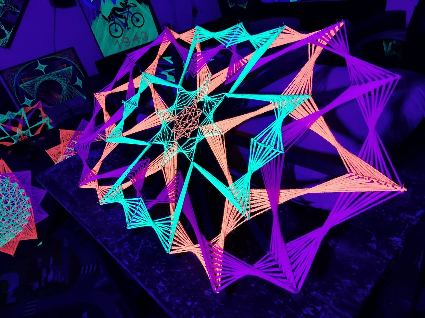 Colorsun geometric string art knitted on wooden slats, handmade wall art with colorful threads reacting to light, modern fiber art design