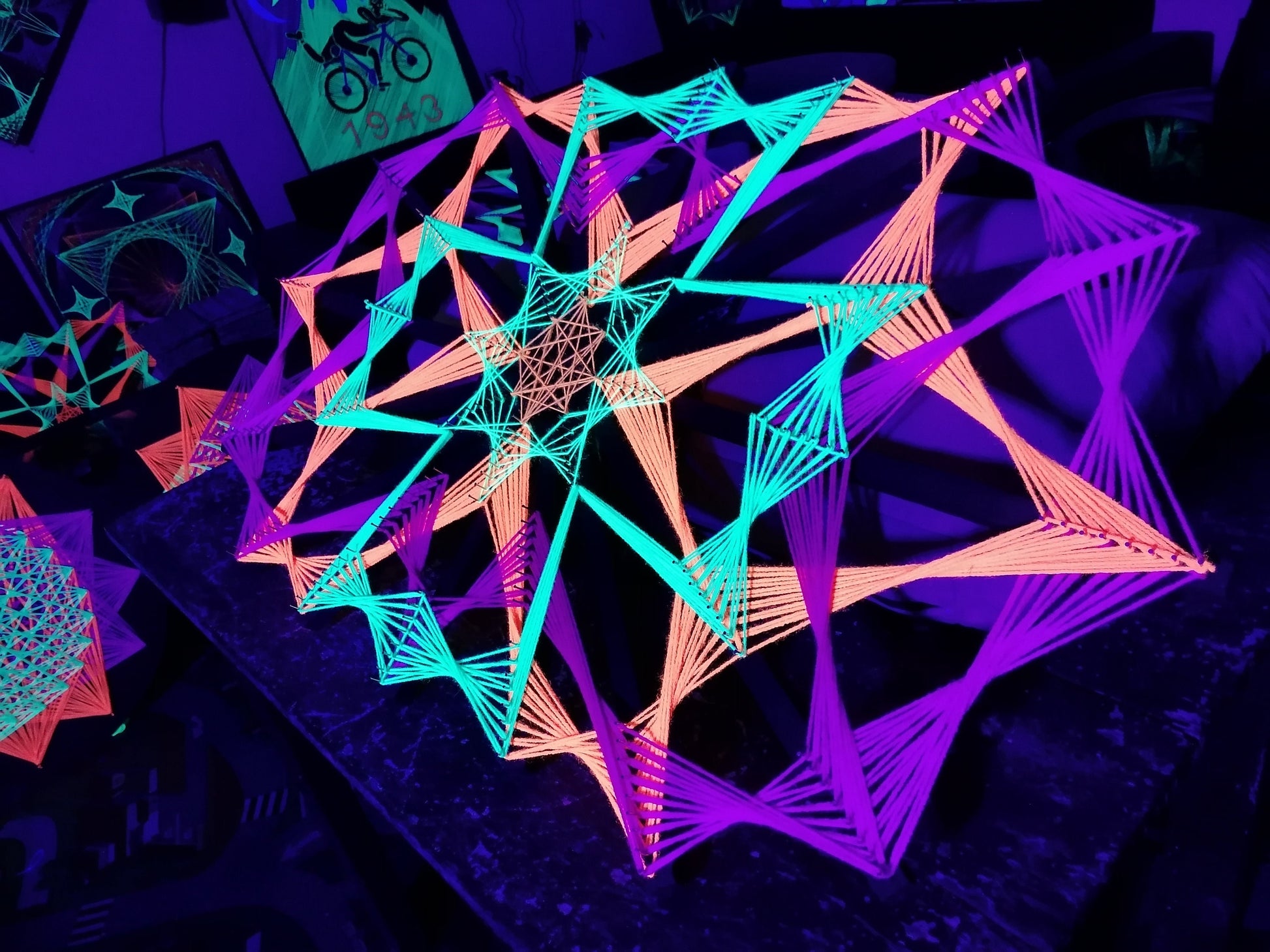 Colorsun geometric string art knitted on wooden slats, handmade wall art with colorful threads reacting to light, modern fiber art design