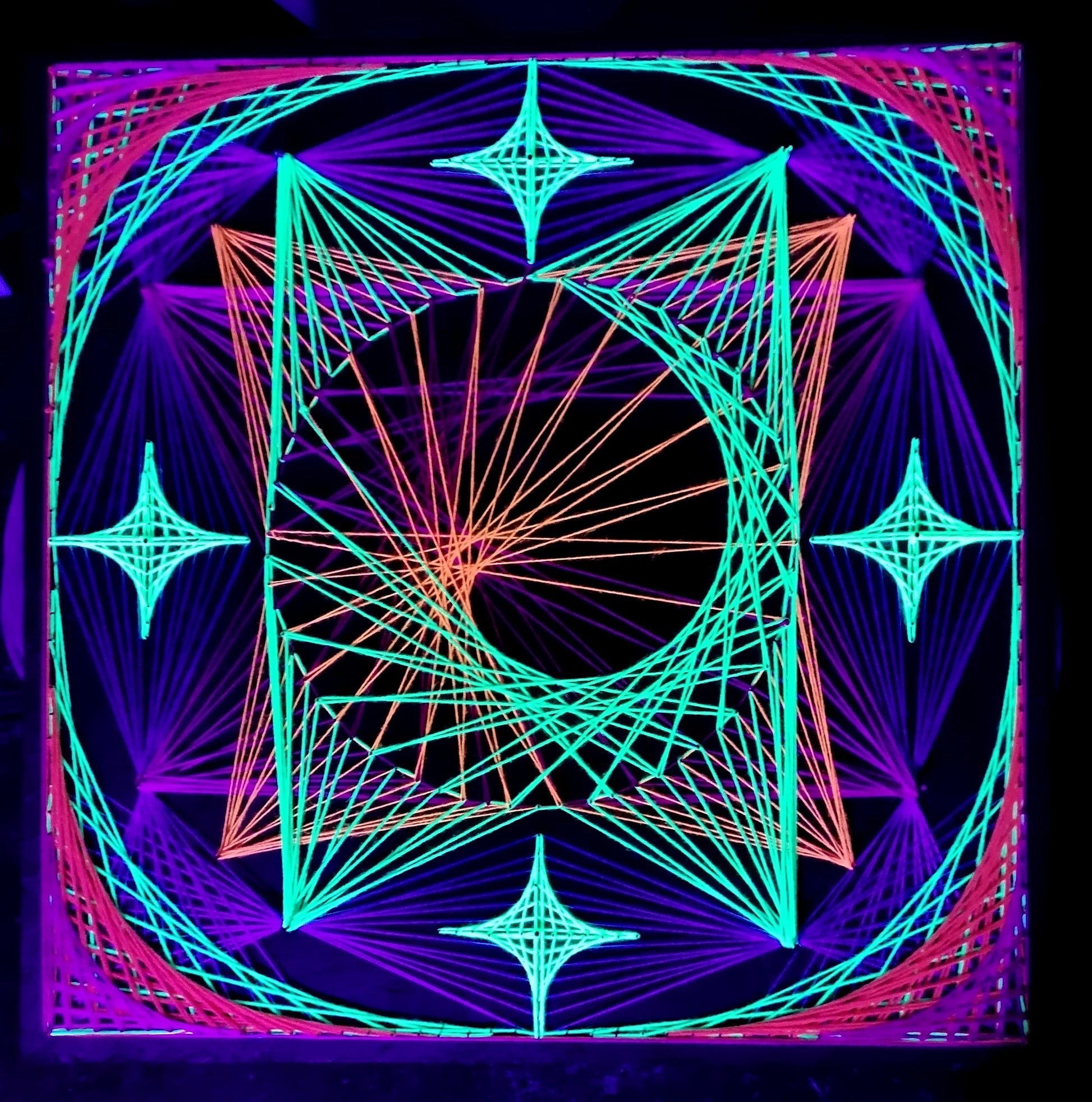 handmade square string art with symmetrical geometric pattern, UV reactive, central triangular structure and four star motifs, multicolor threads on dark background, by Psybell
