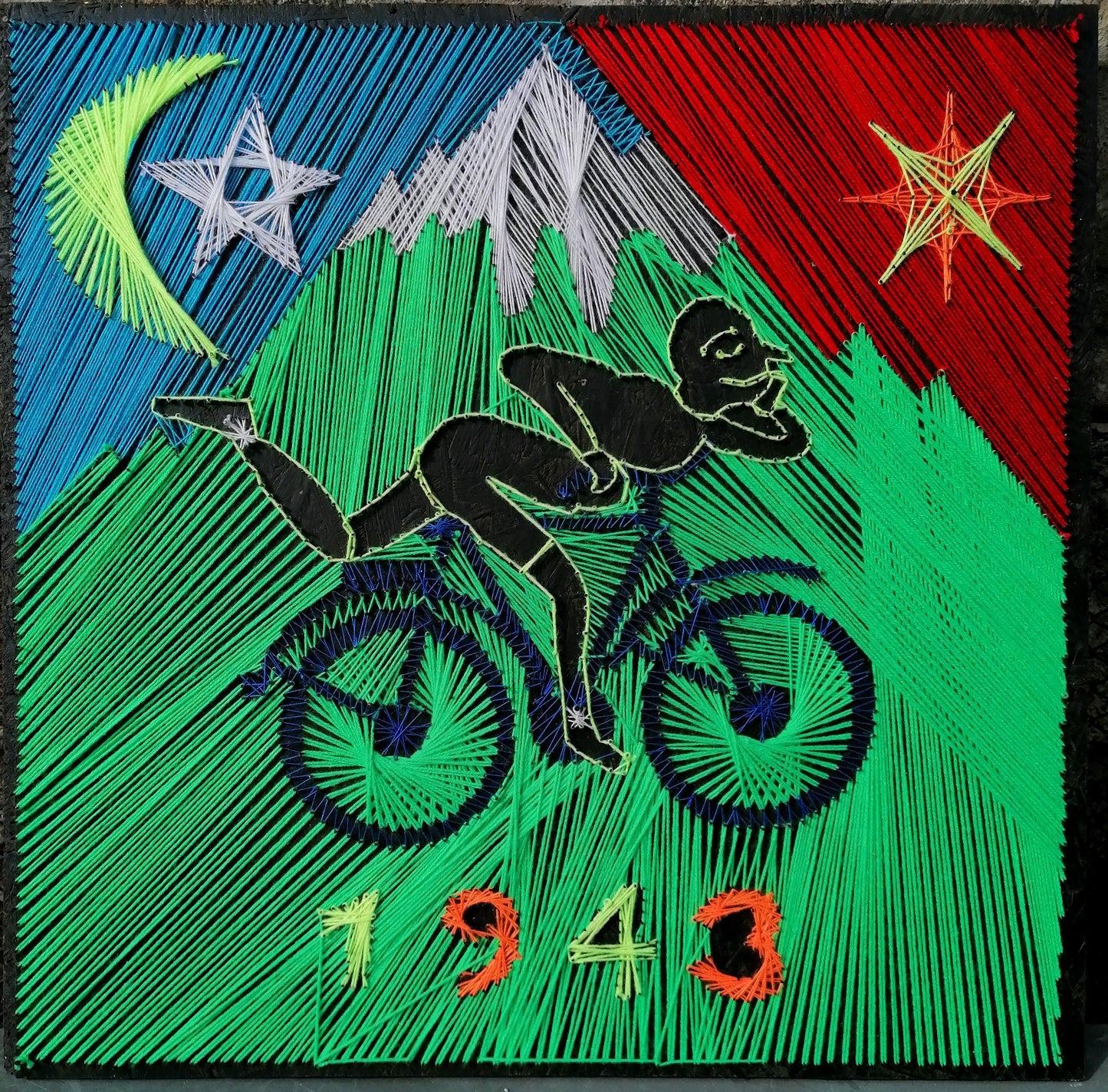 handmade psychedelic string art depicting cyclist silhouette inspired by Hofmann’s Trip, glowing geometric background with moon and stars, UV reactive threads on black board, modern wall art, Psybell