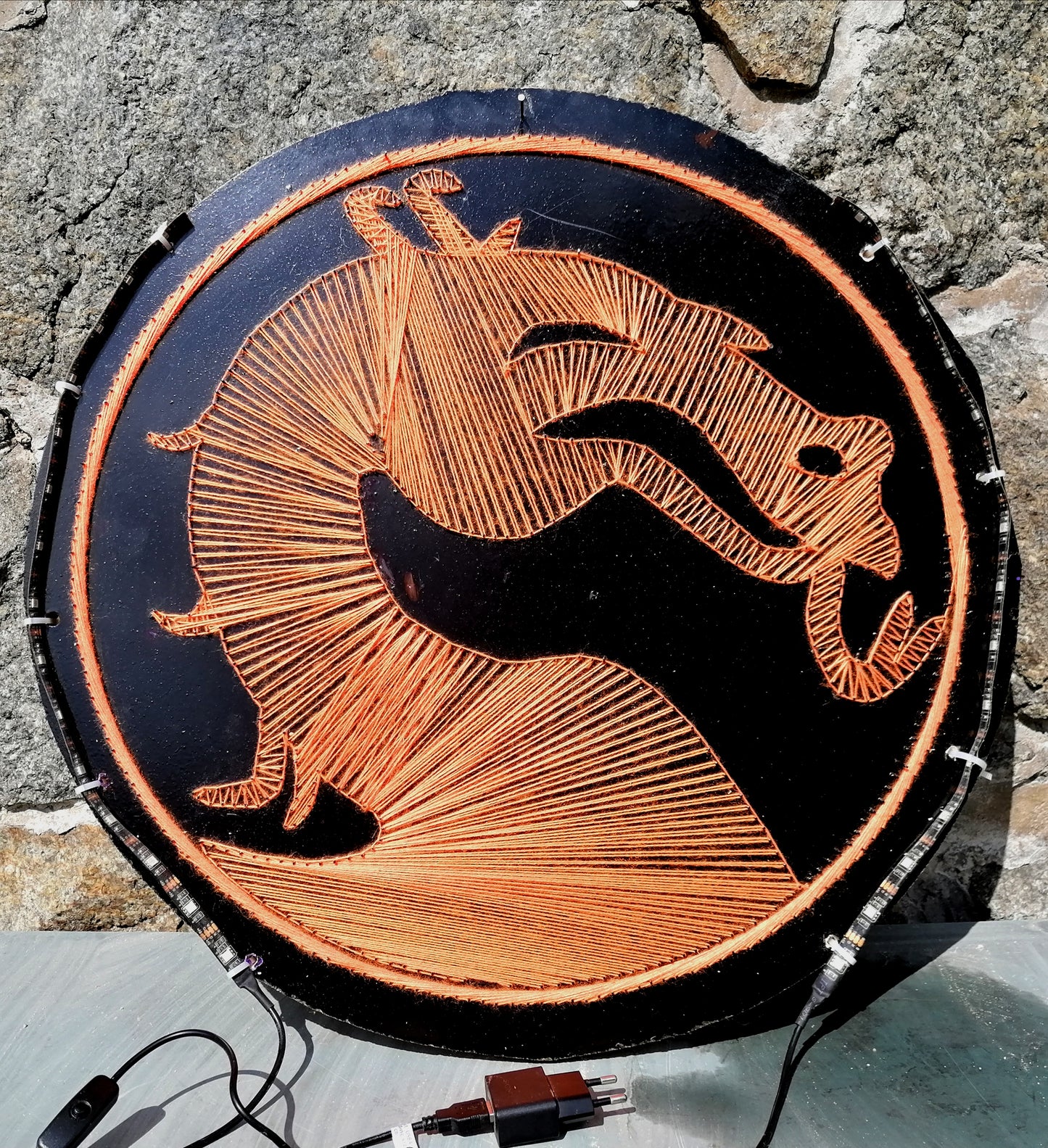 handmade Mortal Kombat dragon logo string art on black circular MDF board, copper thread geometric line art, LED backlit wall artwork