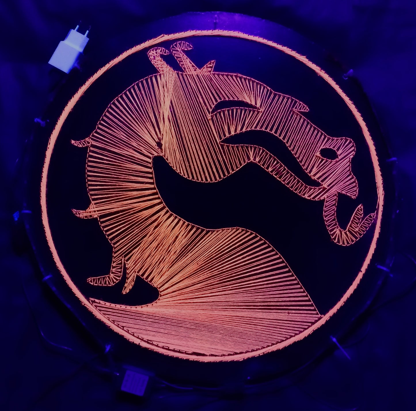 handmade Mortal Kombat dragon logo string art on black circular MDF board, copper thread geometric line art, LED backlit wall artwork