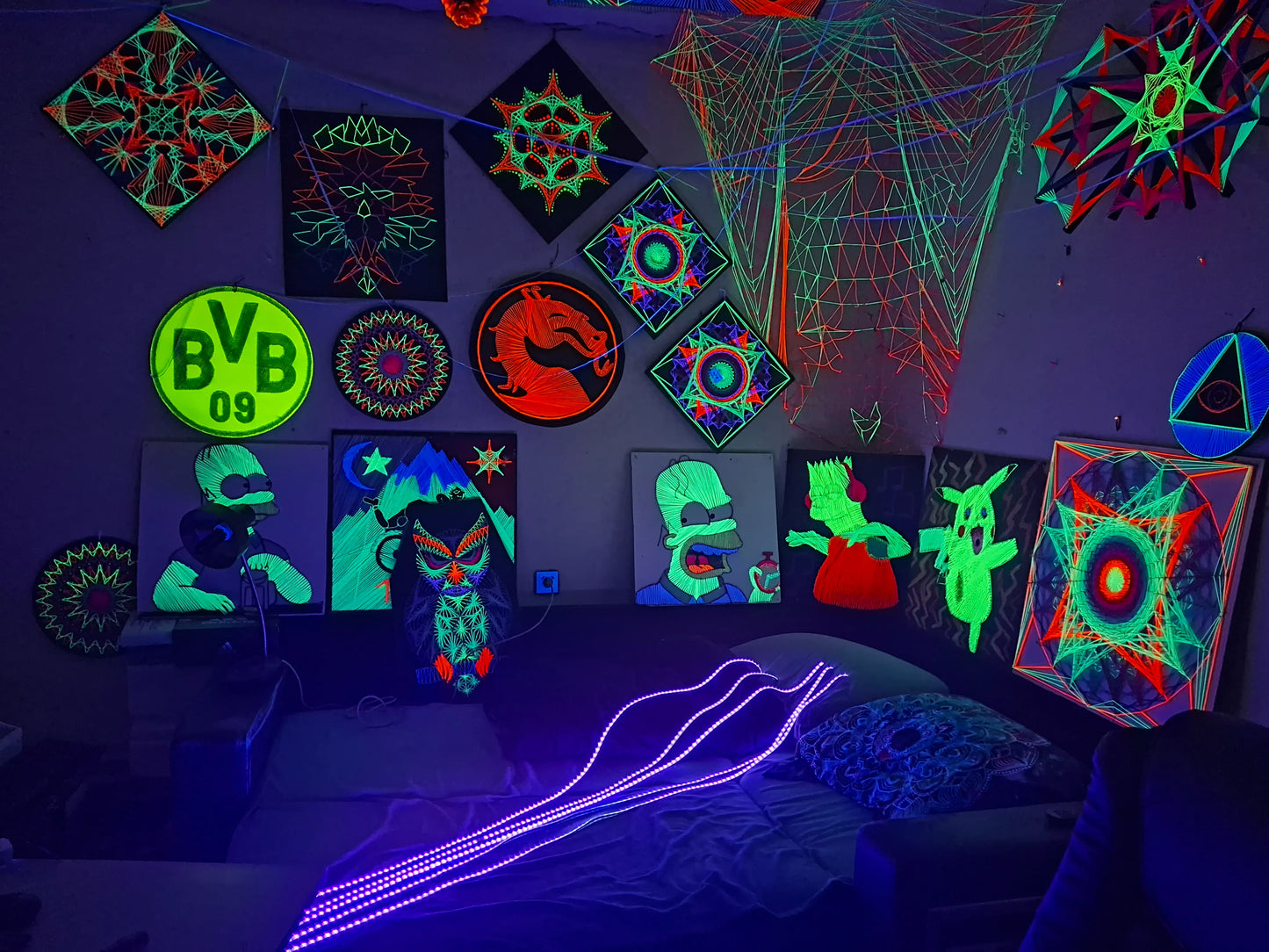 Neon glowing artworks on a dark wall with various shapes and patterns. Art from Slovakia by Psybell