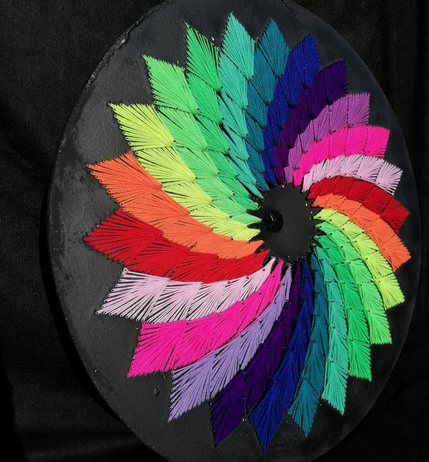 handmade string art circle with symmetrical geometric pattern, rainbow colors design, made from synthetic acrylic threads on MDF wood board, by Psybell
