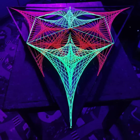 handmade UV reactive string art artwork with alien motif, geometric structure, glowing under ultraviolet light, by Psybell - from Slovakia
