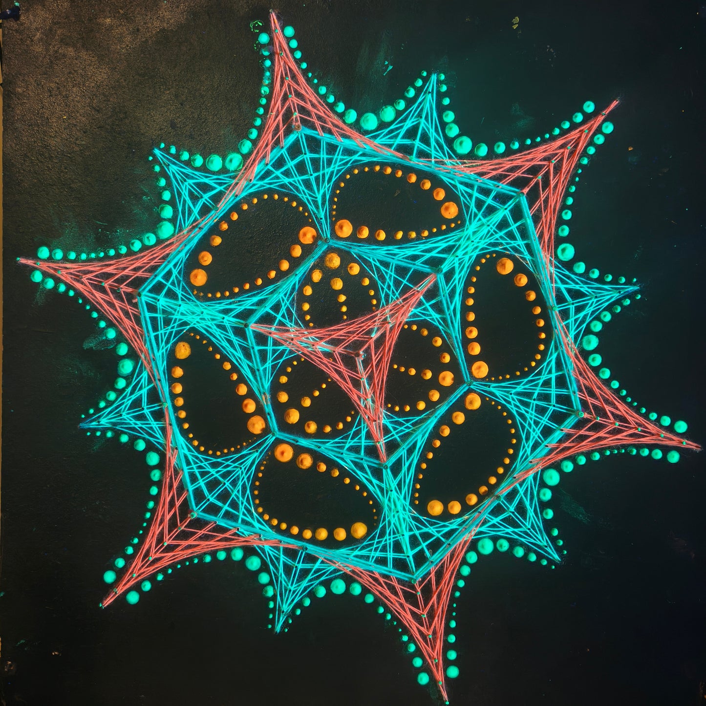 handmade UV reactive geometric string art with transformer pattern and dotted mandala, neon turquoise, red and yellow elements on black background, symmetrical psychedelic composition, by Psybell
