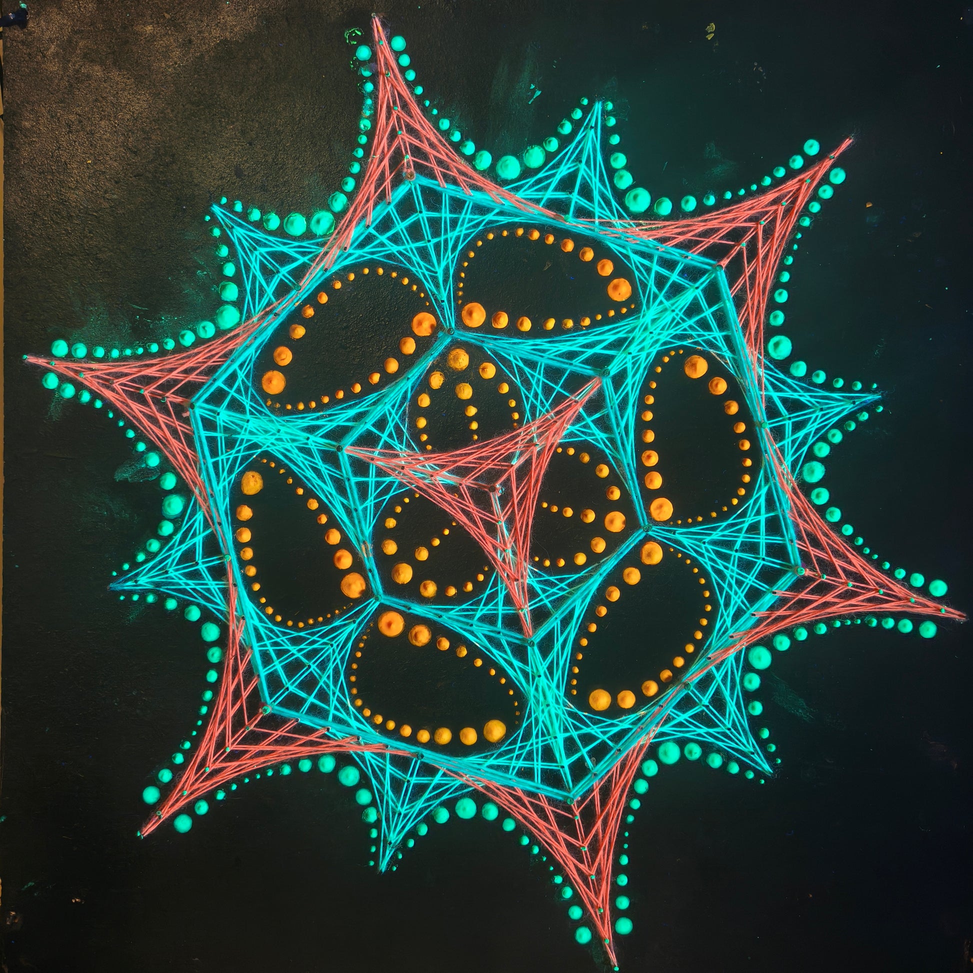 handmade UV reactive geometric string art with transformer pattern and dotted mandala, neon turquoise, red and yellow elements on black background, symmetrical psychedelic composition, by Psybell