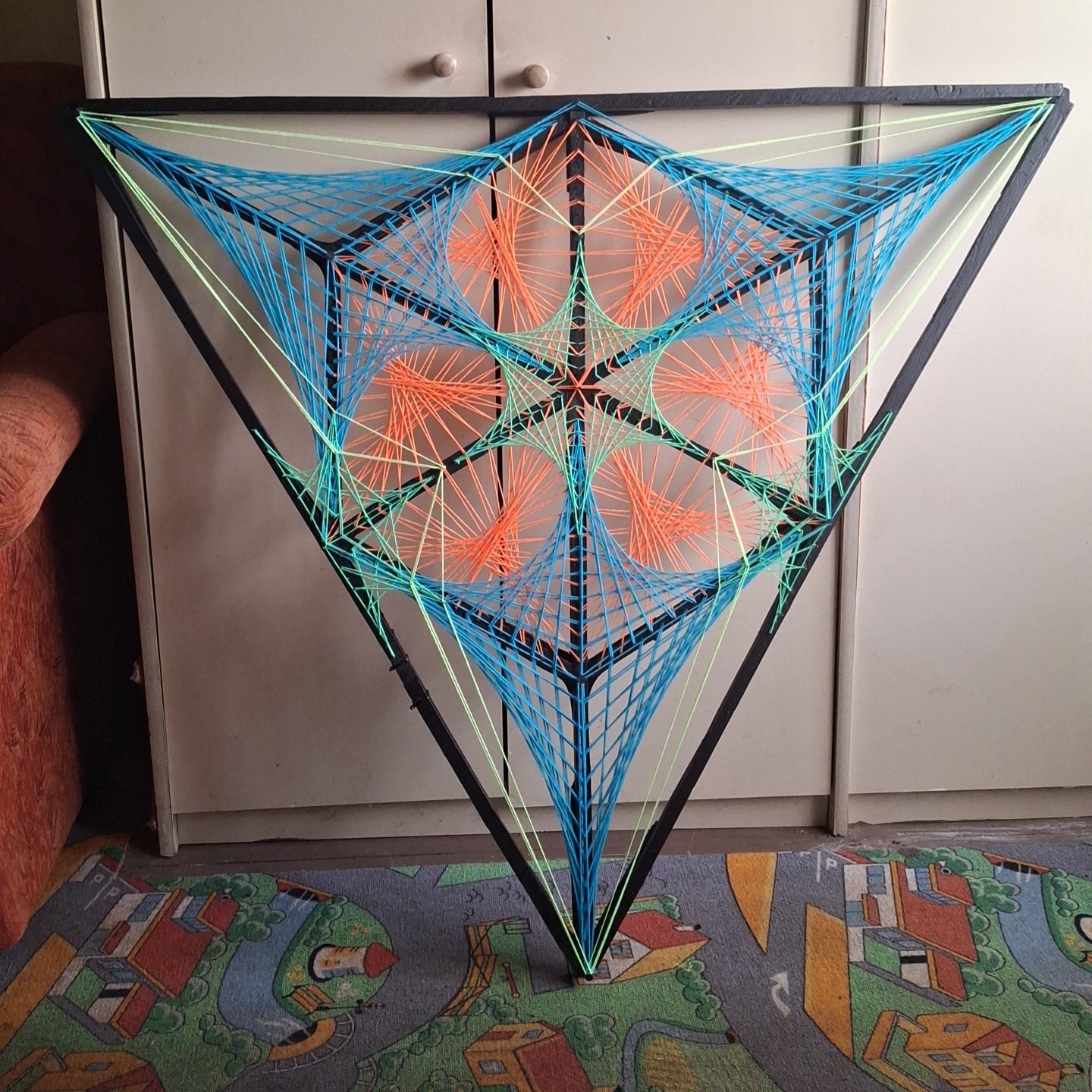 Tripple Double Mitsubishi handmade string art wall sculpture in real interior setting showing size and geometric structure