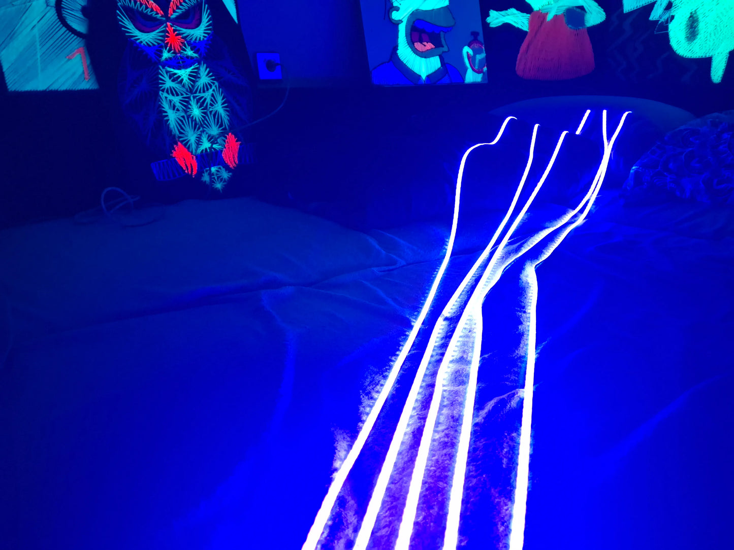 Ultra-violent lights on a bed with colorful string art background by Psybell