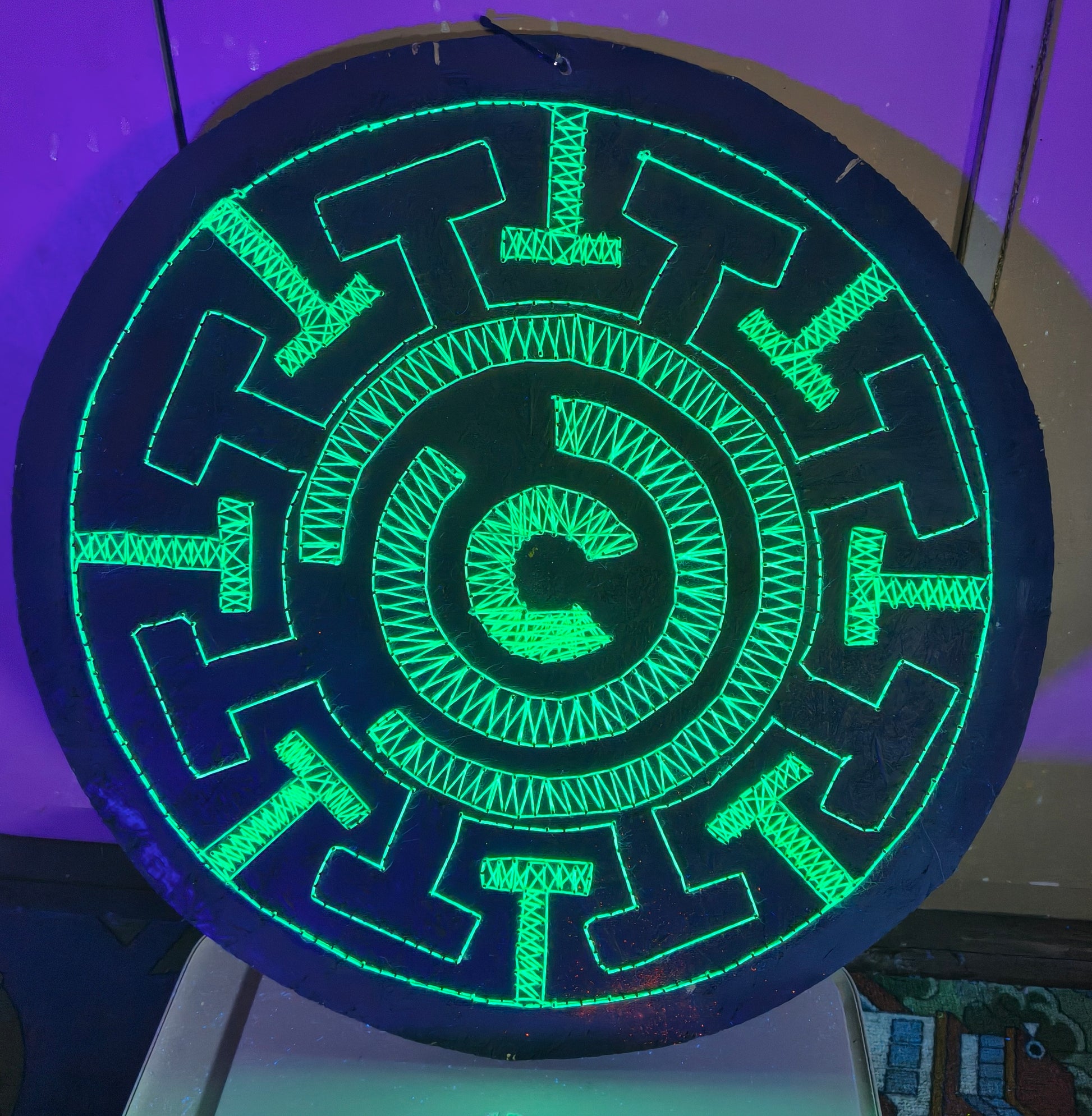 Fluorescent green UV string art Labyrinth mandala geometric wall art detail on black wooden board