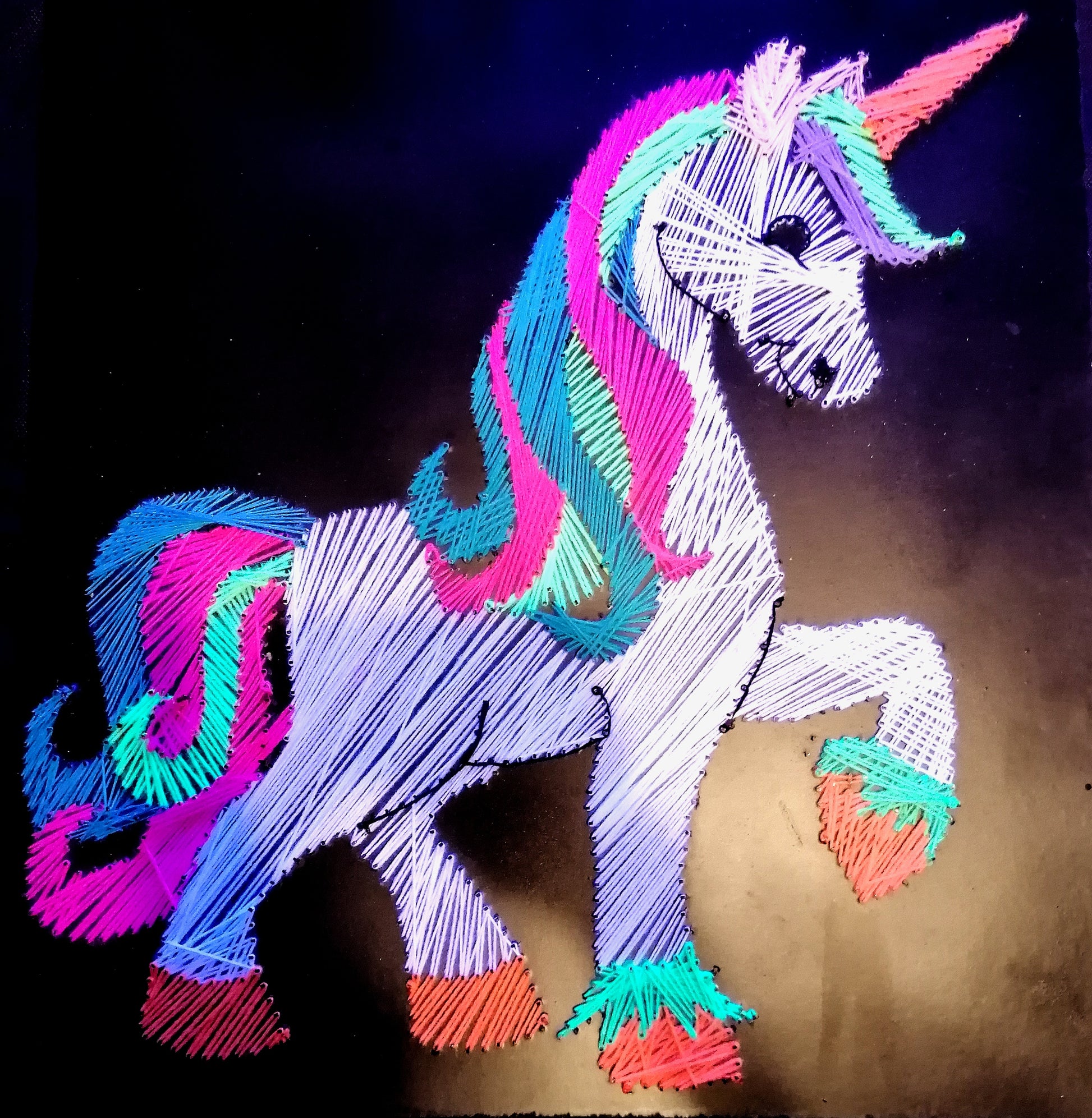 UV reactive unicorn string art with neon cotton threads glowing under blacklight by Psybell