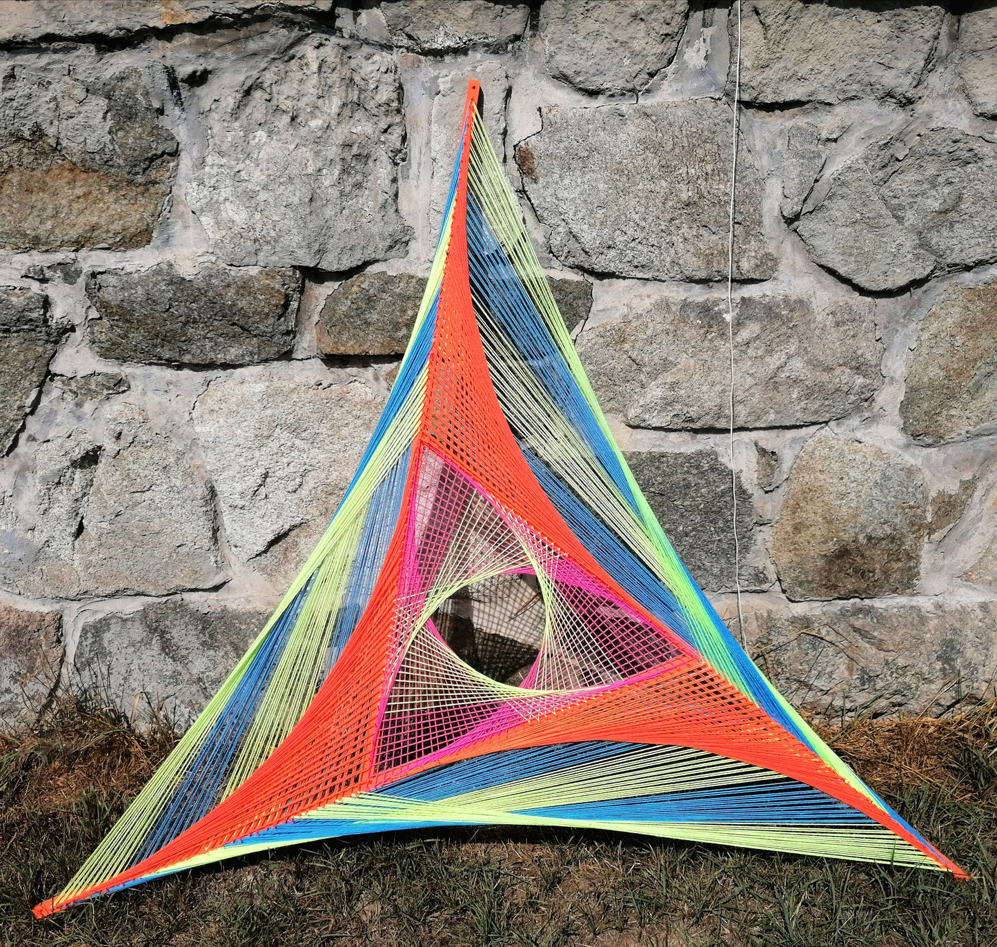 Handmade Windmill string art on wooden slats, geometric triangular design woven with neon UV threads