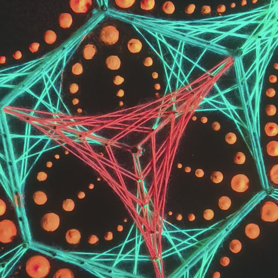 Macro video of dotted mandala string art “Transformer” by Psybell showing colorful thread geometry and dotted pattern