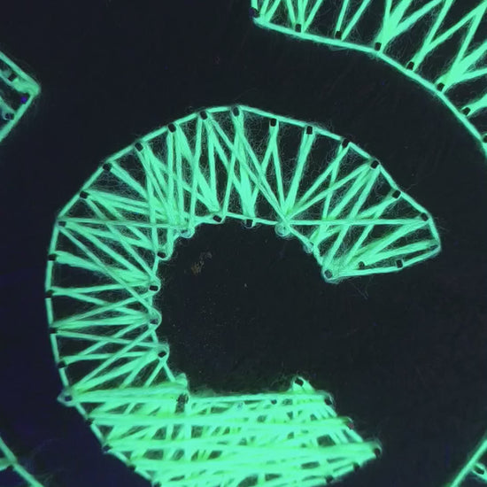 Detailed view of handmade Labyrinth UV string art mandala fluorescent geometric wall art under blacklight. Art by Psybell