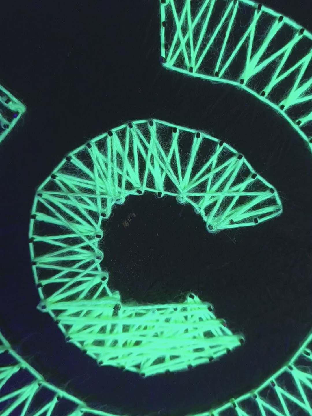 Detailed view of handmade Labyrinth UV string art mandala fluorescent geometric wall art under blacklight. Art by Psybell