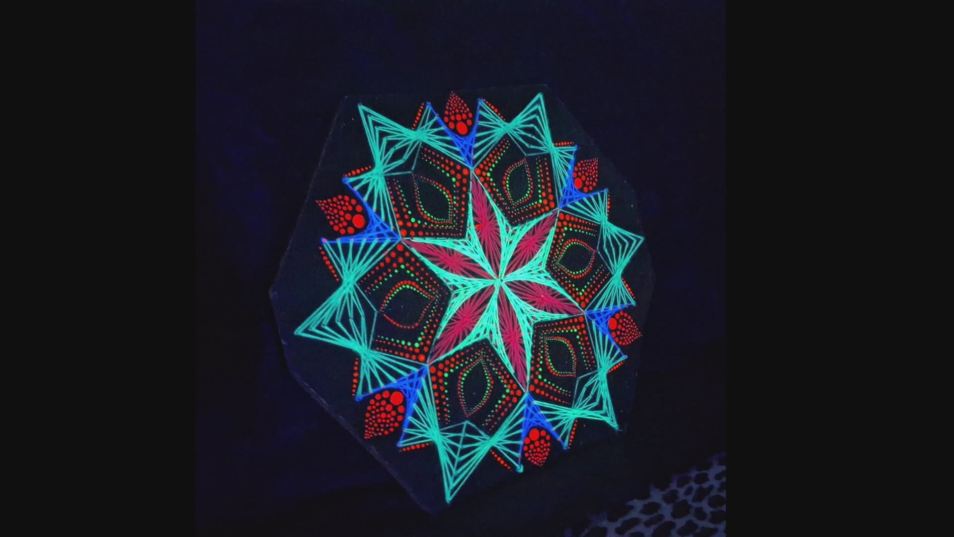 Macro detail video of geometric string art mandala “Blooming Anise” by Psybell showing handmade threads and dotted mandala pattern on wooden board