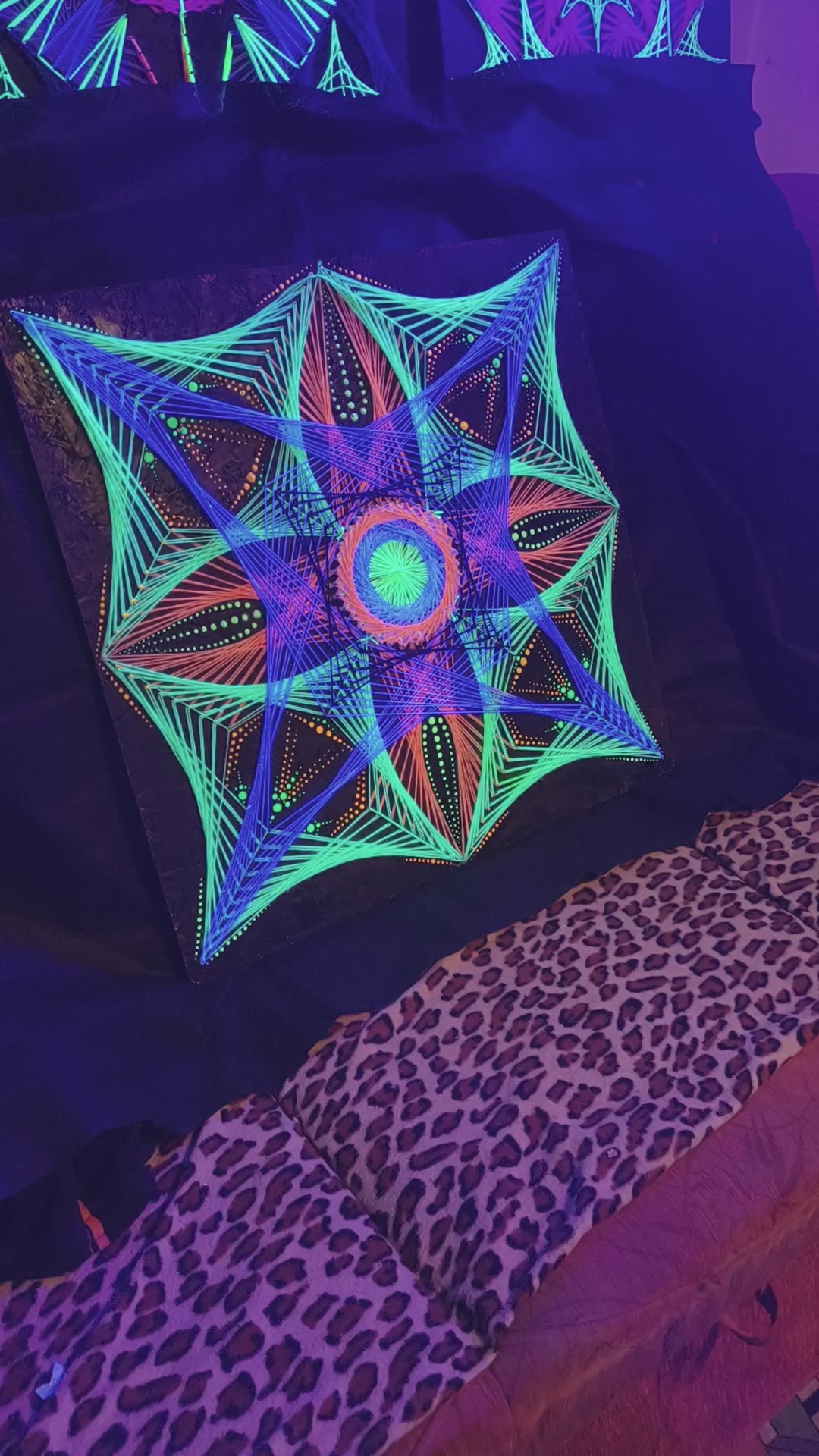 Macro UV glow video of geometric string art mandala “Aura Flow” by Psybell under blacklight showing fluorescent threads and dotted mandala details