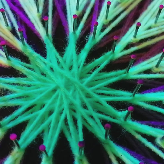 Jellyfish Pattern UV string art mandala – detailed neon purple and lime green radial geometry glowing under blacklight, handmade wall art