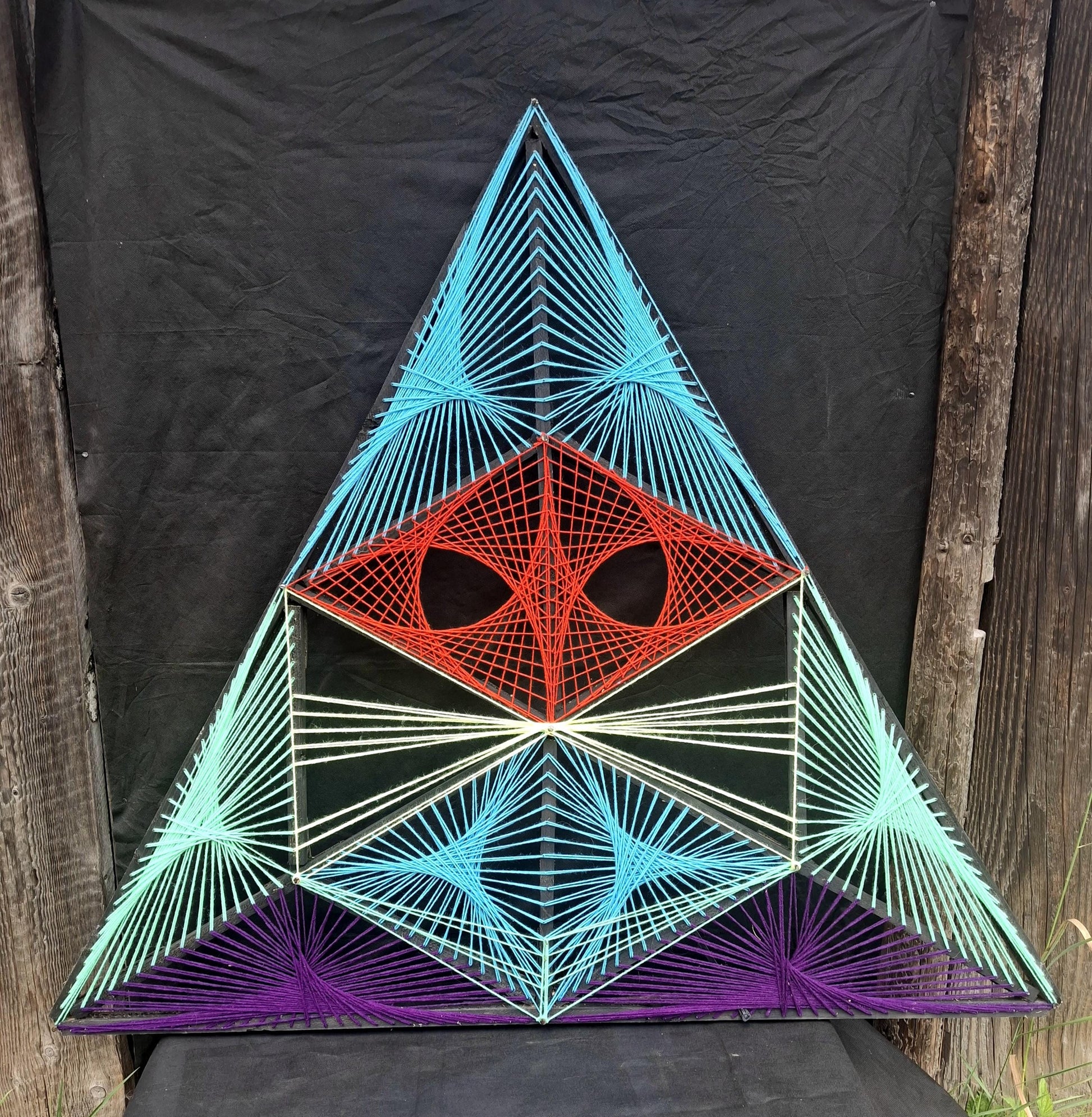 Front view of Aliens Sentinel geometric string art sculpture by Psybell on dark background