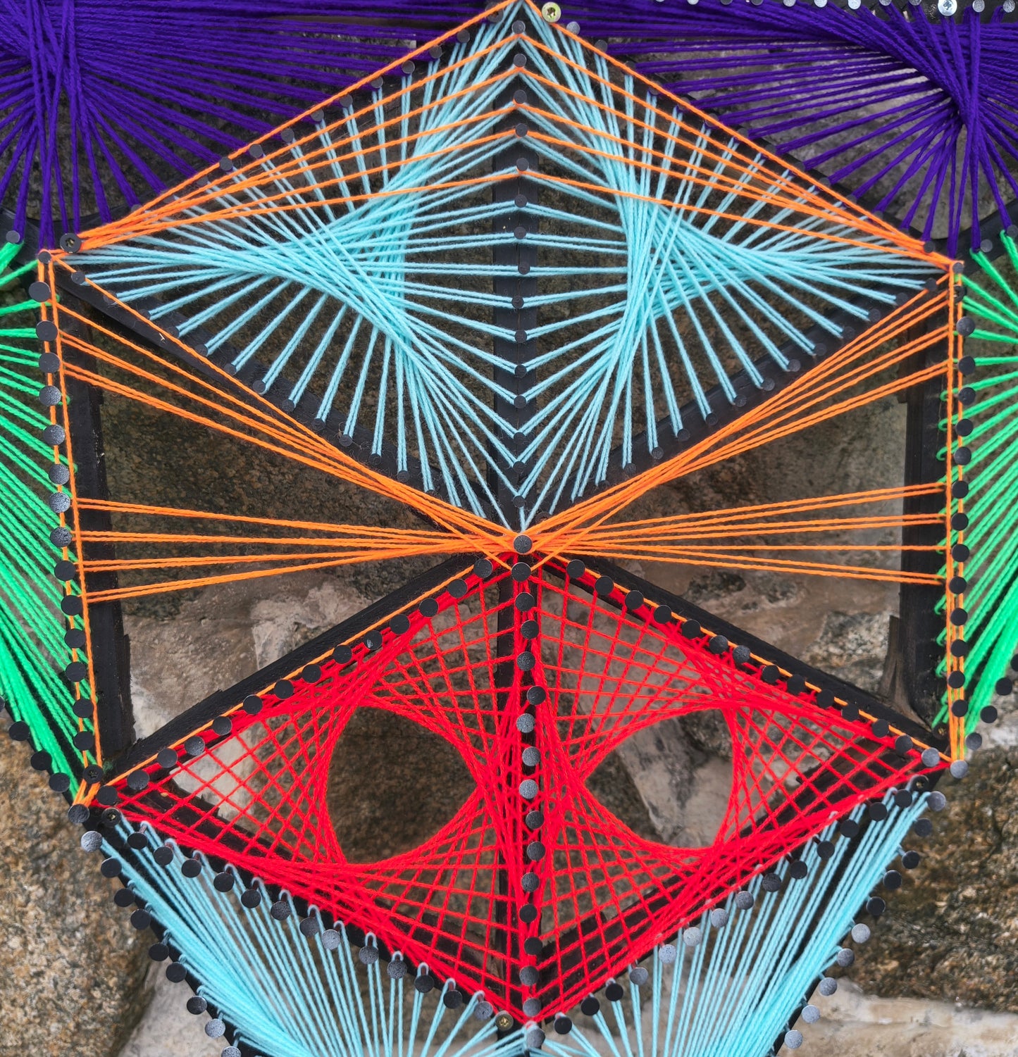 Detail of Aliens Sentinel Mini geometric string art by Psybell showing colorful thread pattern