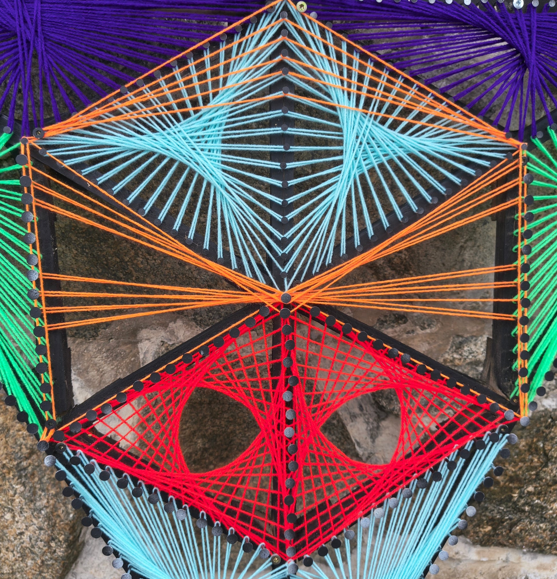 Detail of Aliens Sentinel Mini geometric string art by Psybell showing colorful thread pattern